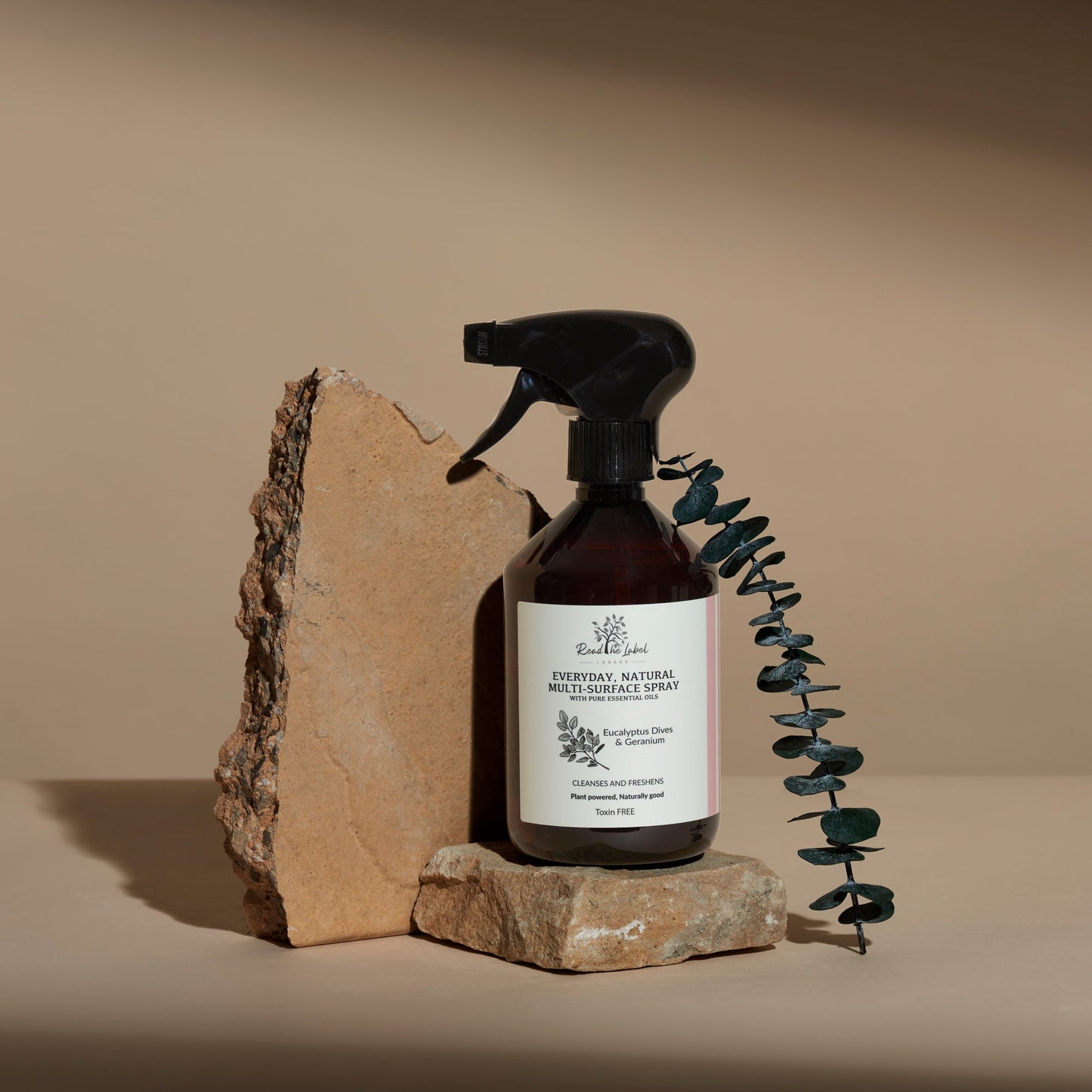 Natural multi-surface cleaner by Read The Label London with eucalyptus and geranium, showing spray bottle and fresh ingredients.