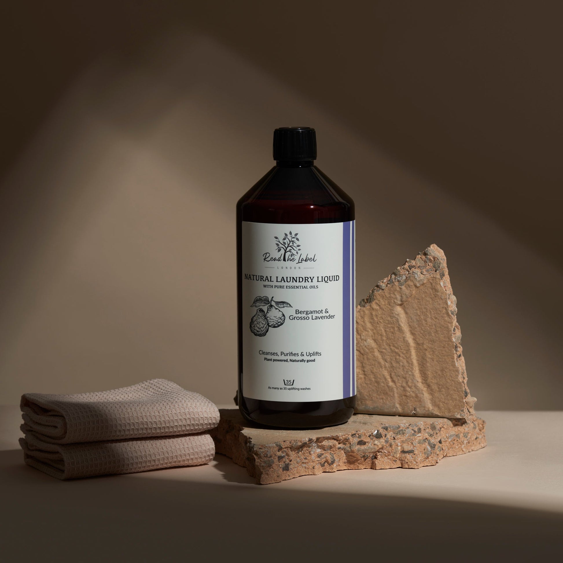 Natural laundry liquid fabric refresher with bergamot and grosso lavender scent by Read The Label London, showing a bottle and fresh lavender.